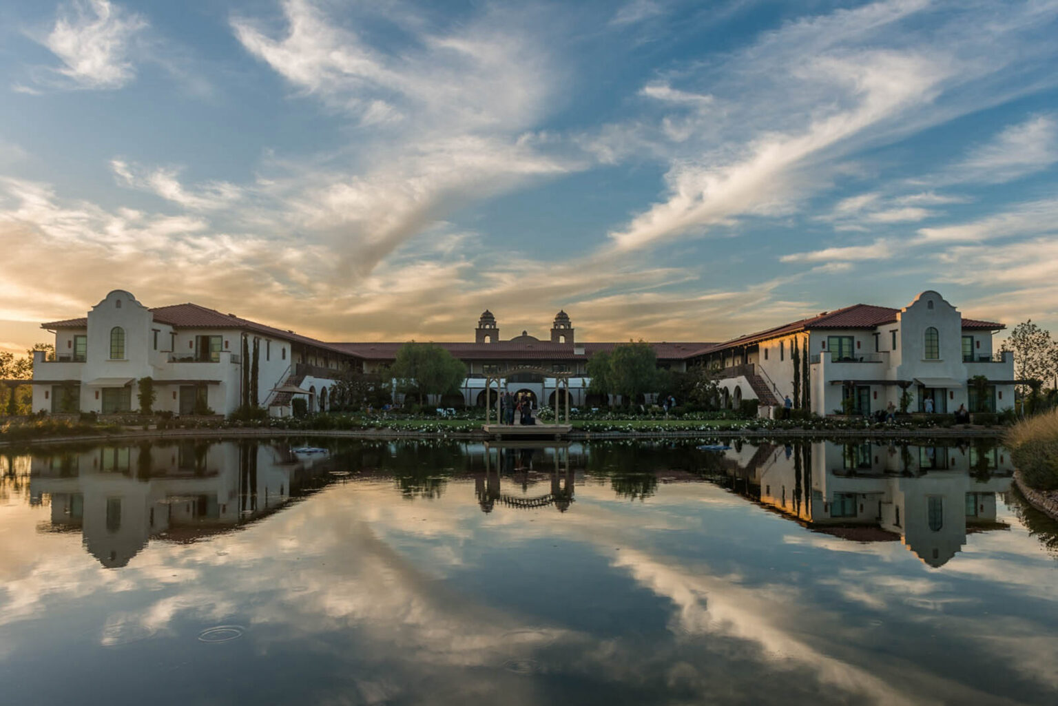 Ponte Vineyard Inn, back of the pond view with a beautiful sunset and sky